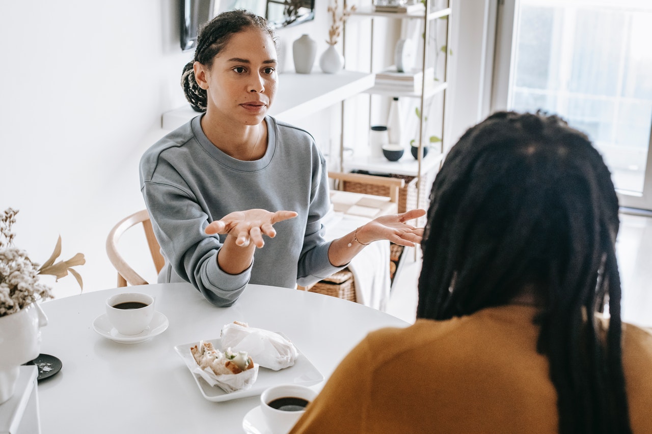 Black couple having a conflict at a table not being patient